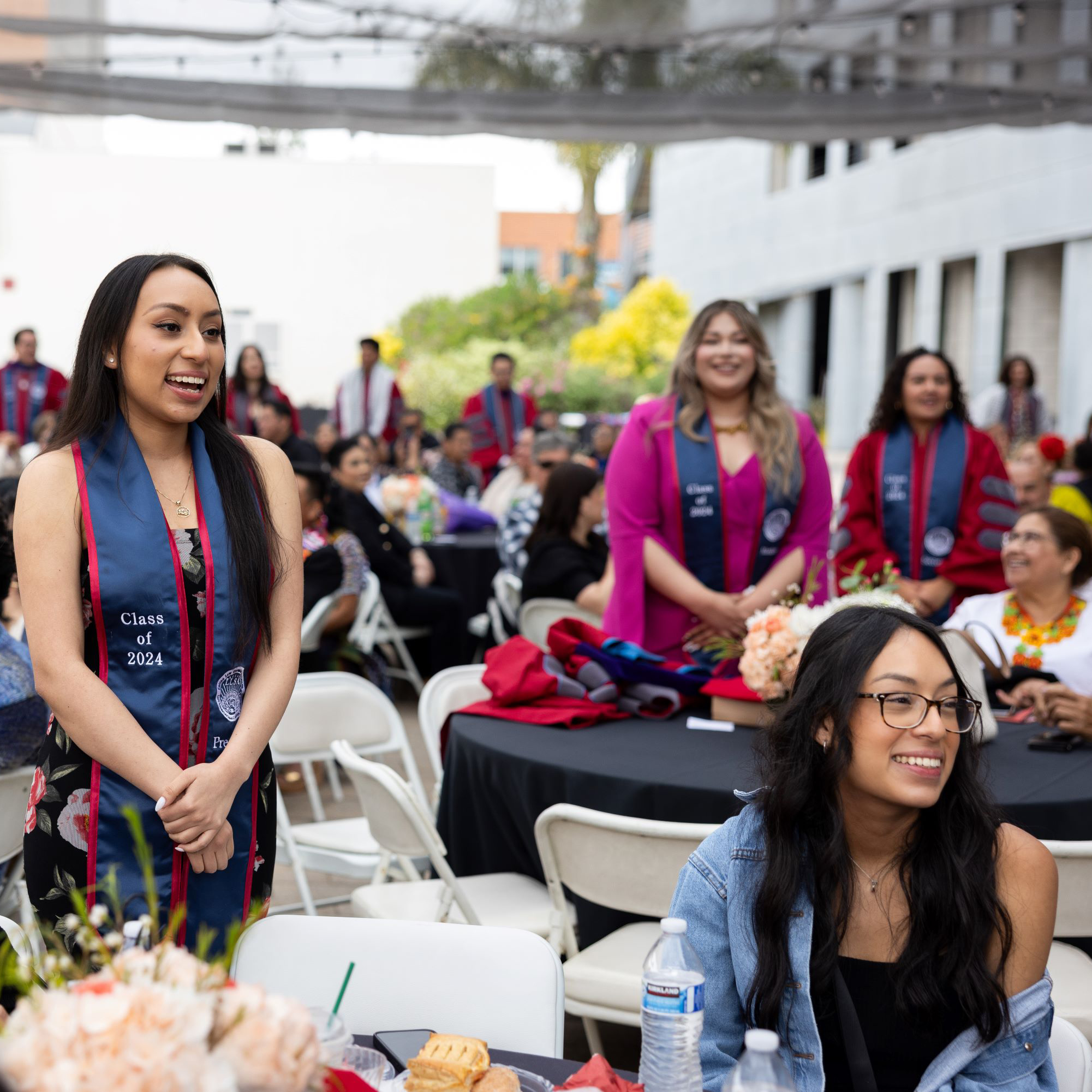 graduates standing up at a table